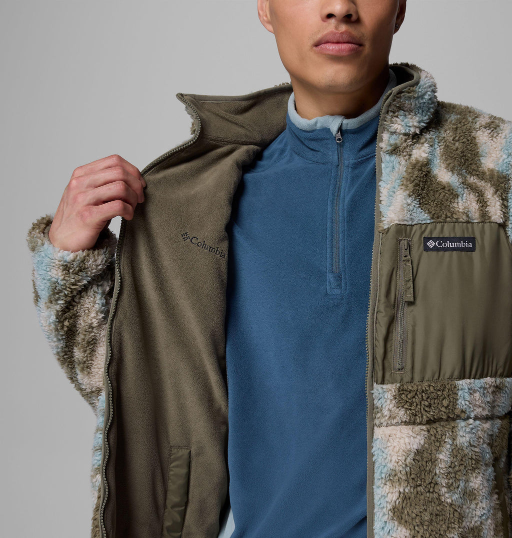Reversible fleece close-up: olive inner side with zip, chest logo patch and pocket
