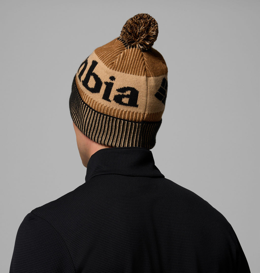 Camel brown knit beanie with pom-pom and bold black letters on front