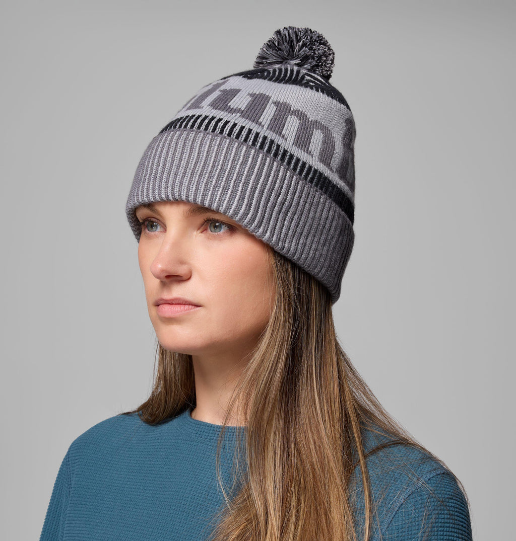 Grey and black pom-pom beanie with ribbed brim and large geometric jacquard motif