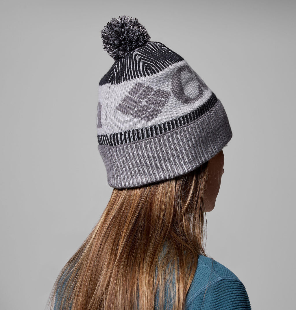 Grey knit beanie with pom-pom and repeating geometric graphic; ribbed lower cuff