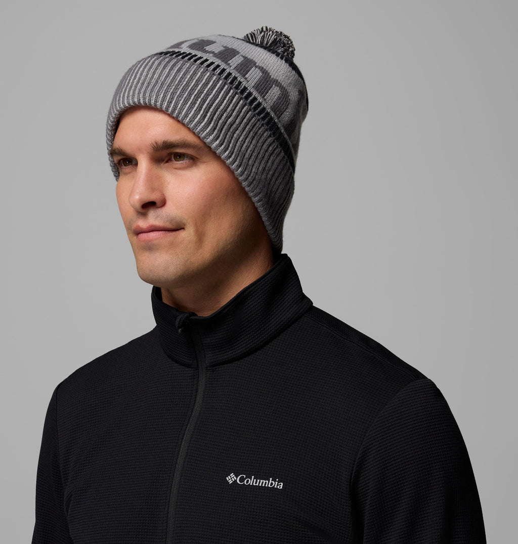 Knit beanie with ribbed cuff, pom-pom top, and black-and-grey geometric patch