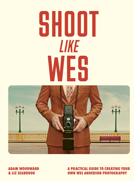 Photography guide book cover, man holding camera, red title text