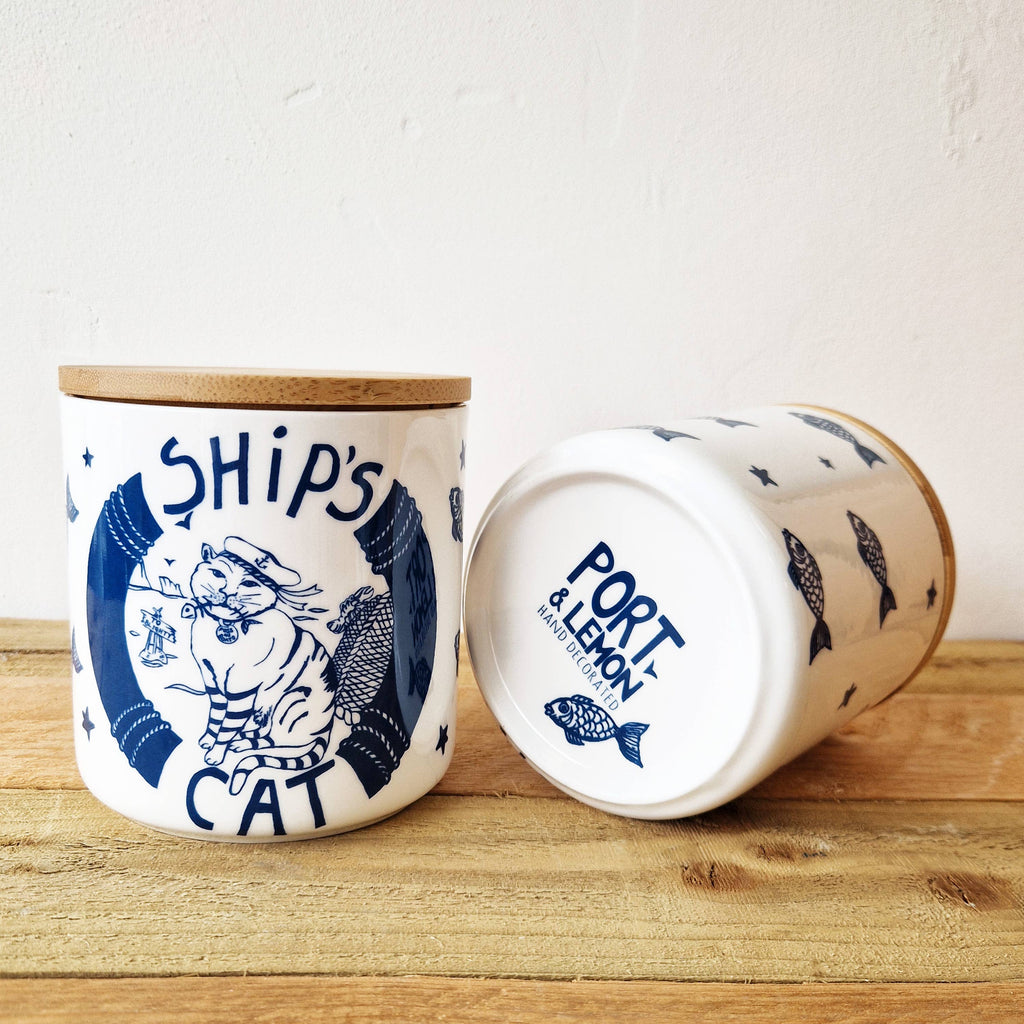 White ceramic cat treat jar with blue cat graphic and cork bamboo lid