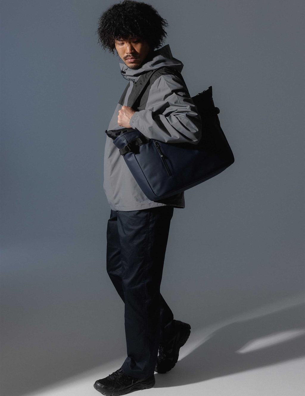 Midnight blue laptop tote bag with wide shoulder straps and front pocket detail