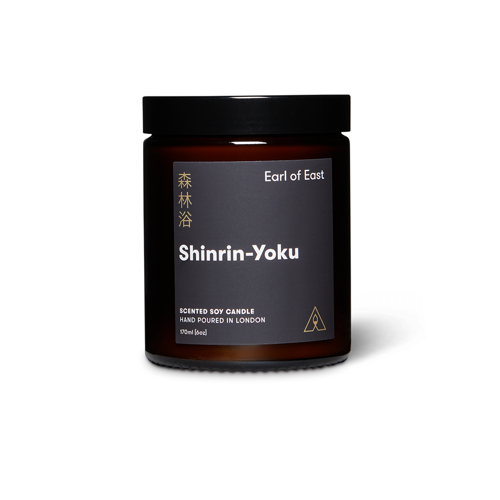 Soy wax candle jar in dark amber glass with black lid and Shinrin-Yoku label
