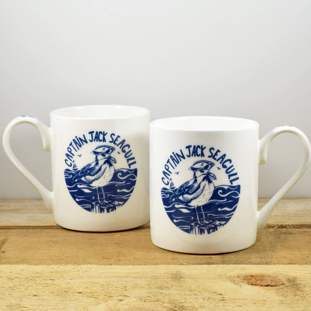White bone china mug pair with blue ship emblem on front