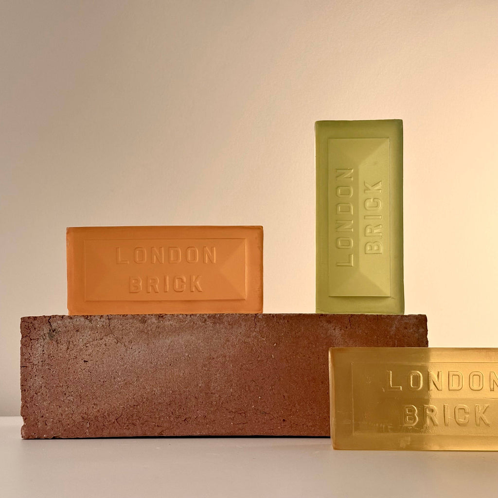 Brick-style soap bars in orange, green, and yellow with "LONDON BRICK" embossing