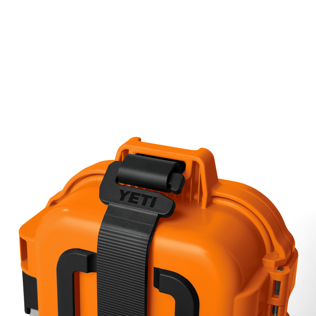 Close-up of orange gear case with black strap and top handle