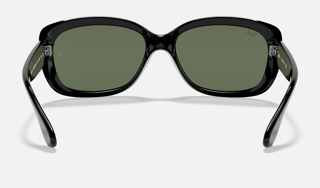 Black sunglasses front view with dark green lenses and arched nose bridge