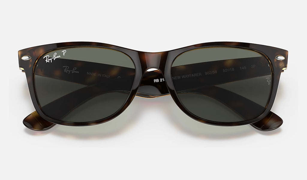 Wayfarer sunglasses close-up, polished tortoise frame with green polarized lenses