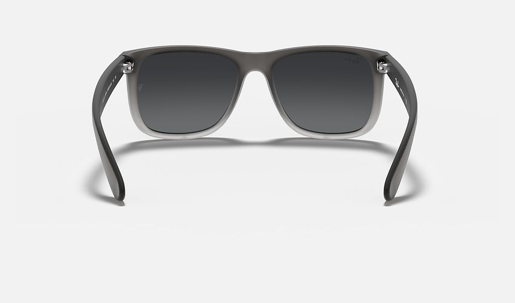 Ray-Ban Justin Classic sunglasses with dark lenses, translucent gray frame, and metal accents.