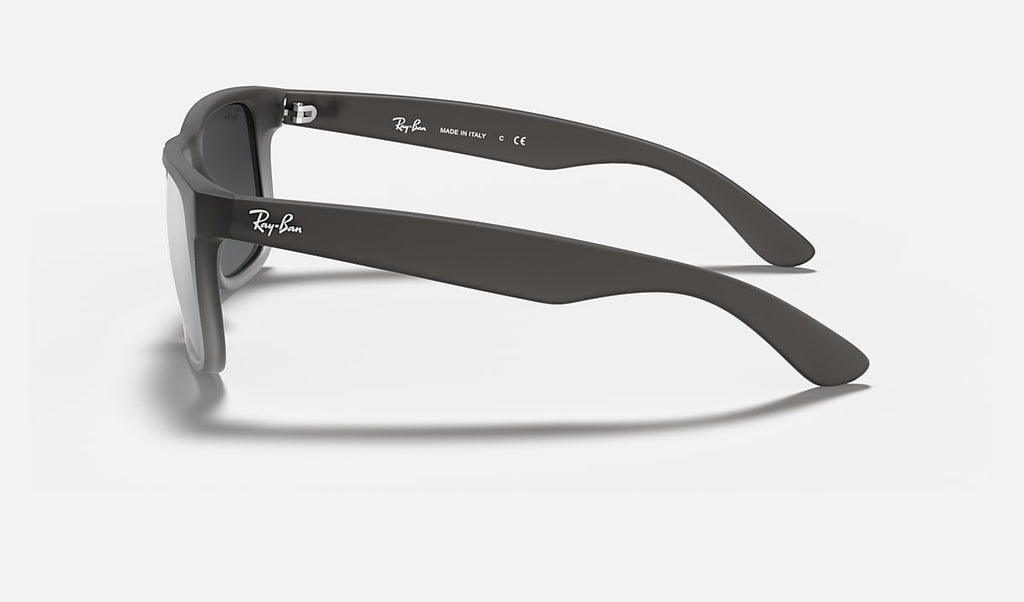 Ray-Ban Justin Classic sunglasses side view with translucent gray arms and dark lenses.