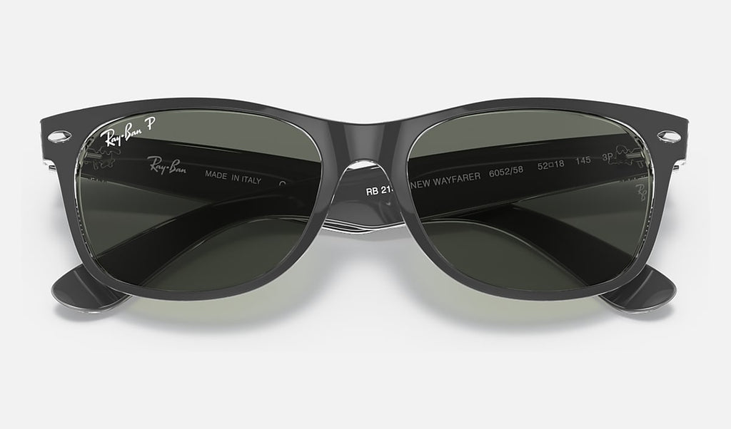 Matte black wayfarer sunglasses with dark green polarized lenses, temple logo detail