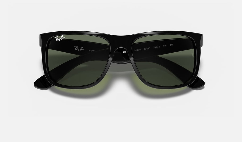 Ray-Ban black sunglasses with dark green lenses, angled top view.