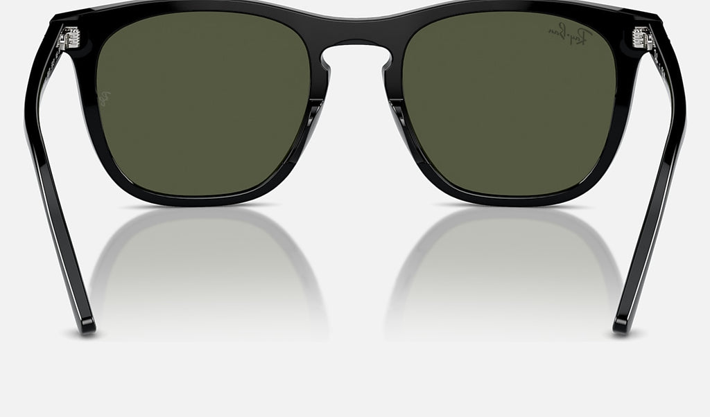Black sunglasses with green lenses, sturdy square frame, metal bridge, Ray-Ban logo.