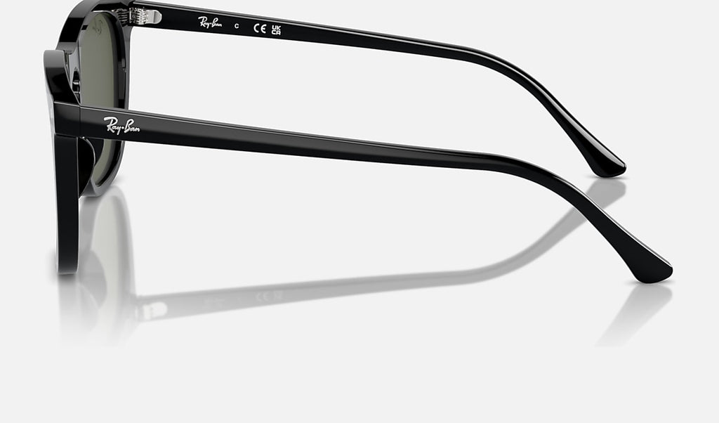 Black sunglasses side view with green lenses and slim temple arm, Ray-Ban logo.