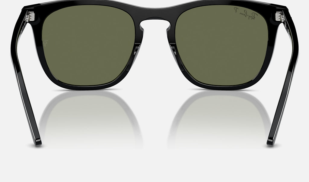 Black sunglasses with green polarized lenses and metal hinge details