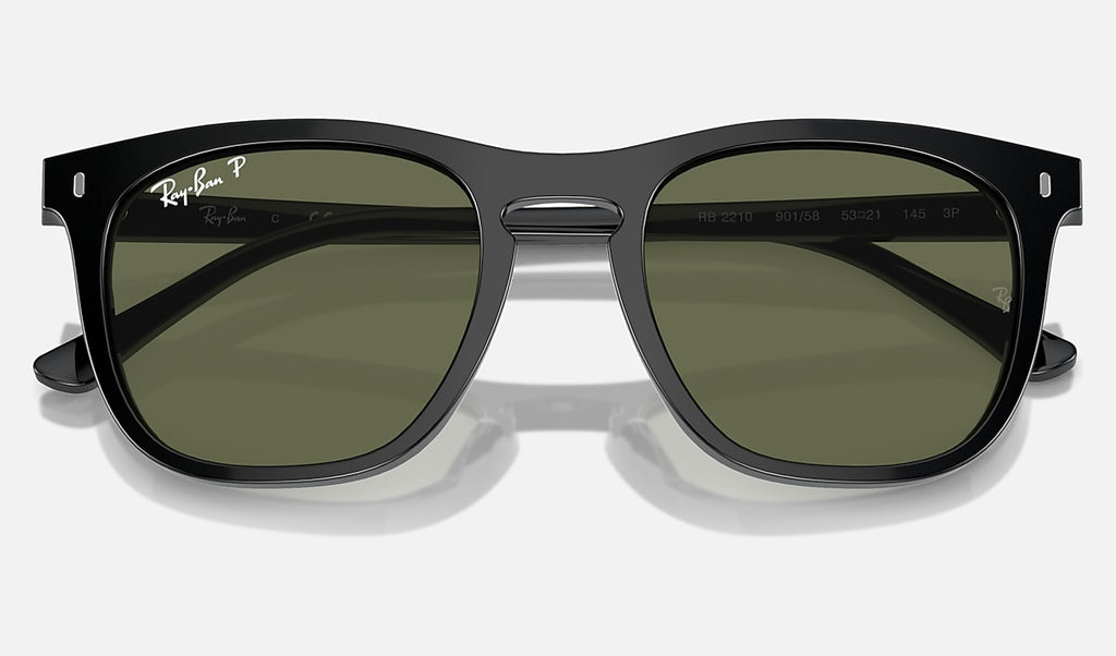 Black sunglasses with green polarized lenses, slightly angled for view of frame