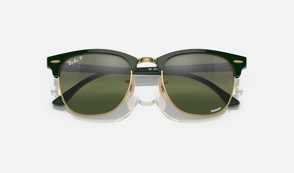 Polished green on gold sunglasses with dark green mirrored polarized lenses, bridge and top view