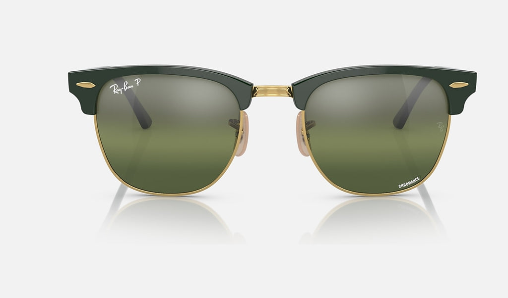 Polished green on gold sunglasses with dark green mirrored polarized lenses, angled front view