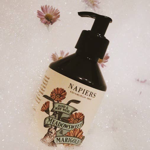 Hand and body wash bottle with black pump, dark amber; front label with Meadowsweet & Marigold