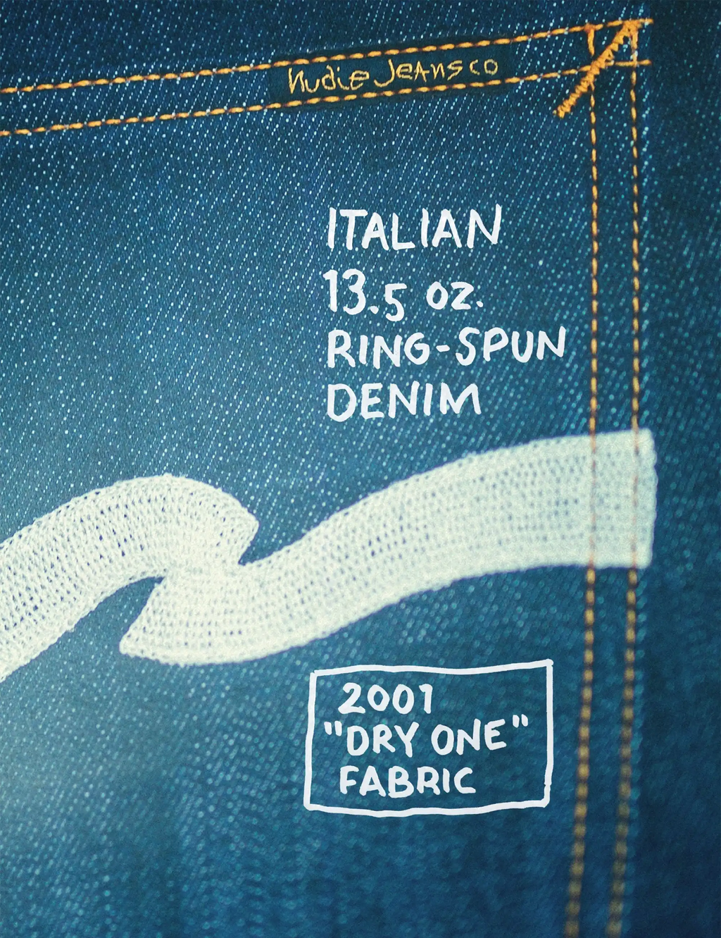 Blue denim fabric label: Italian 13.5 oz ring-spun denim and "Dry One" fabric