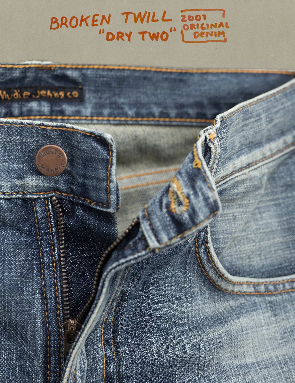 Blue denim jeans with button fly, front pocket and contrast orange stitching