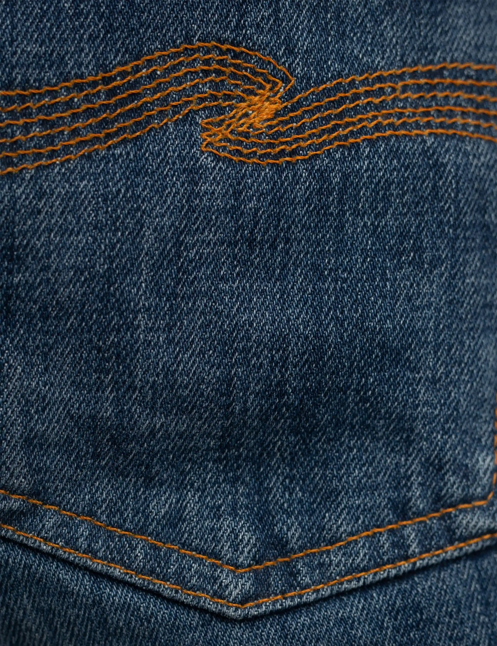 Blue denim jeans back yoke with orange embroidered wave-style stitching