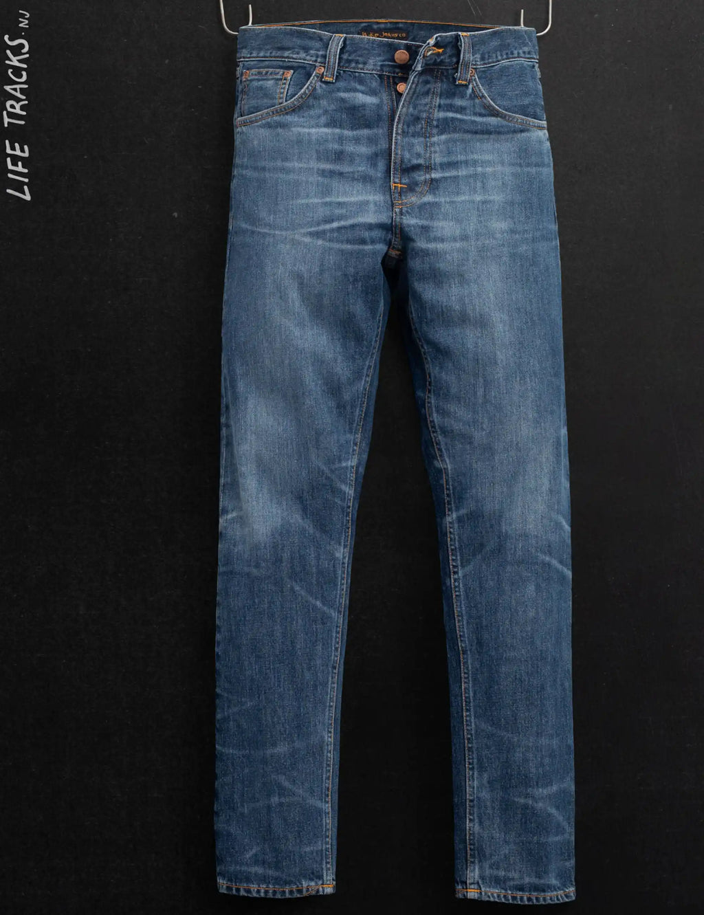 Blue denim jeans with twisted orange contrast stitching, straight leg, belt loops