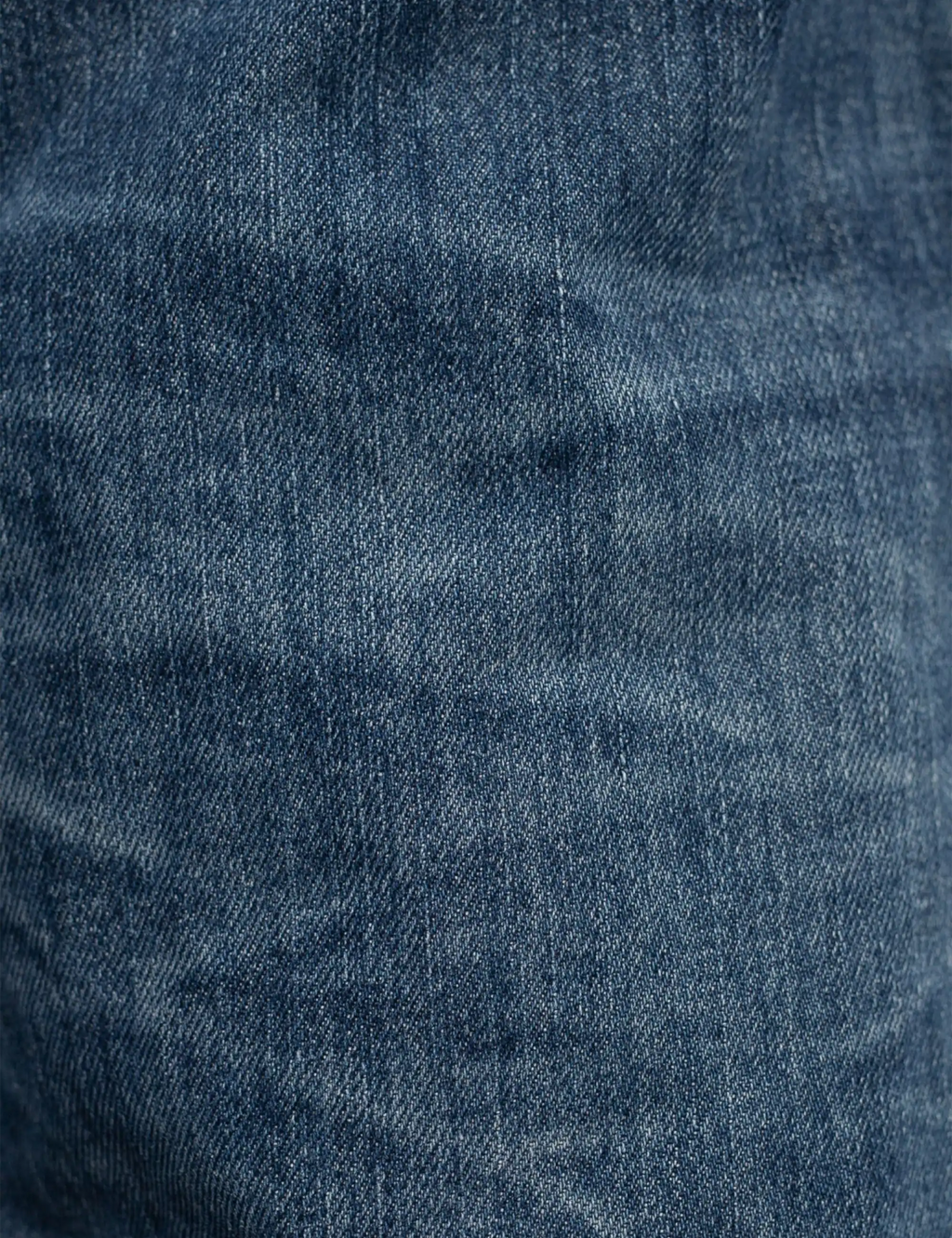 Blue denim jeans fabric with textured wash and fine stitch details