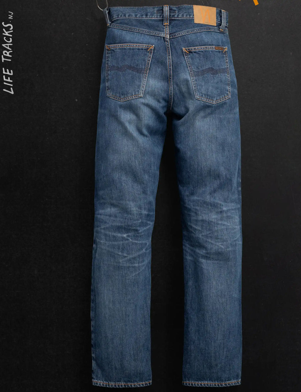 Light blue straight-leg jeans with back pockets and orange contrast stitching