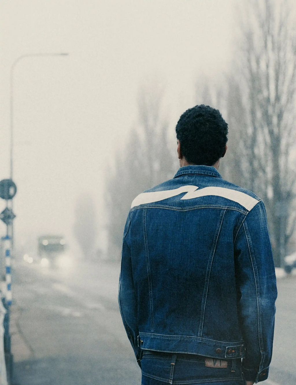 Dark blue denim jacket with cream yoke panel on the back and classic button placket