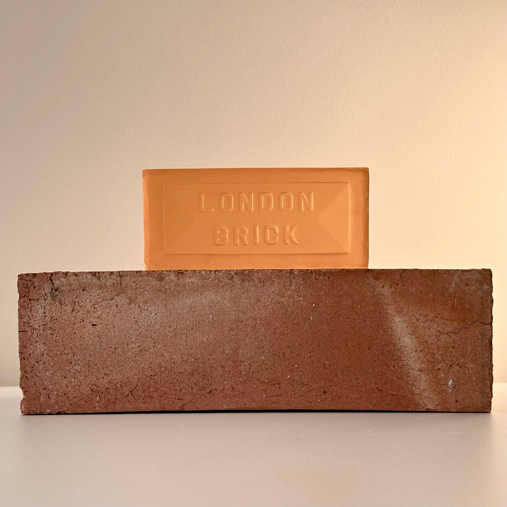 Orange brick-style soap bar with embossed "LONDON BRICK" on a brown brick base