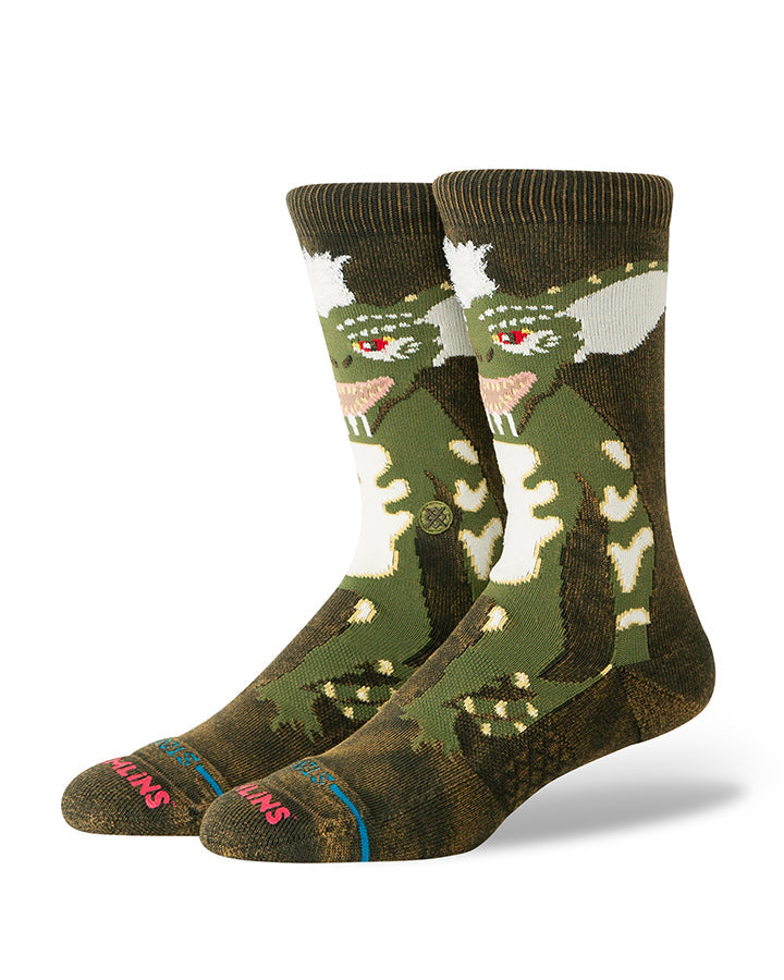 Dark green crew socks with white gremlin faces and cartoon character graphics