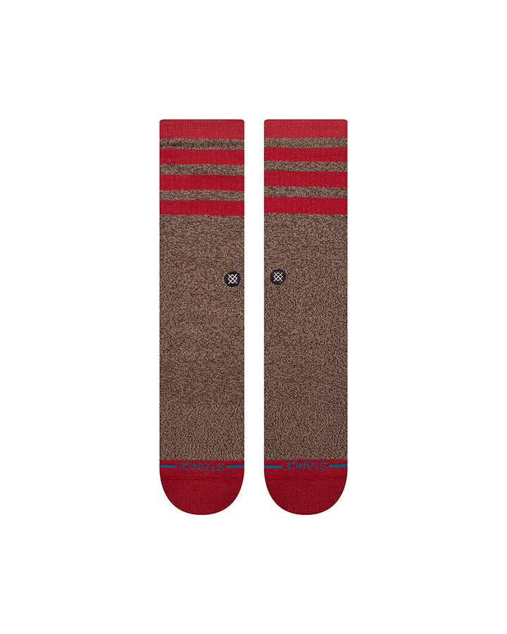Brown crew socks with red striped upper, red toe and heel, small stitched icon near arch