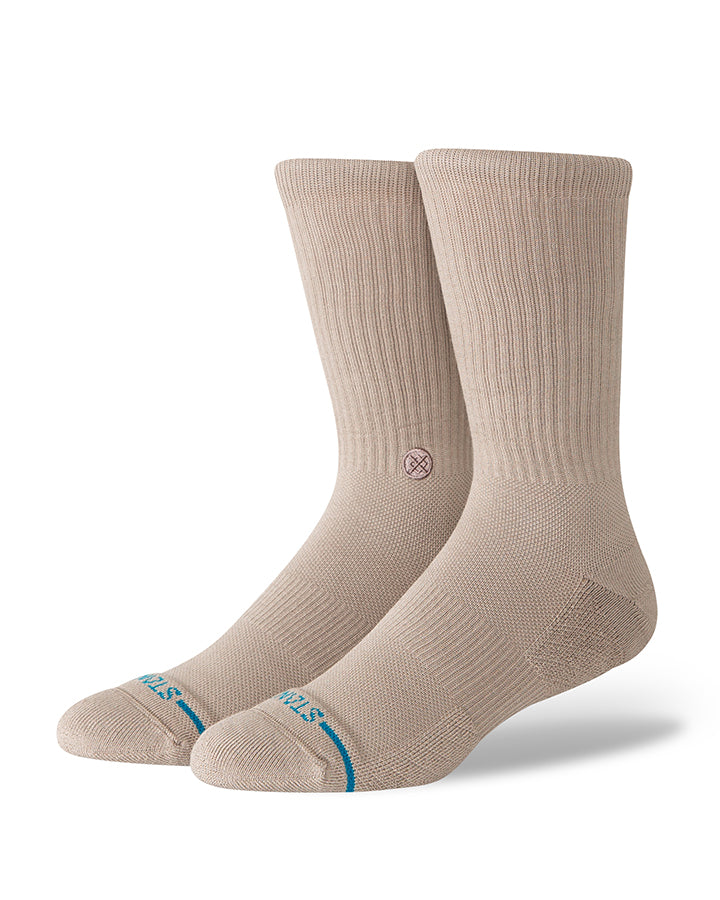 Pair of light gray crew socks with ribbed cuffs and blue logo at toe