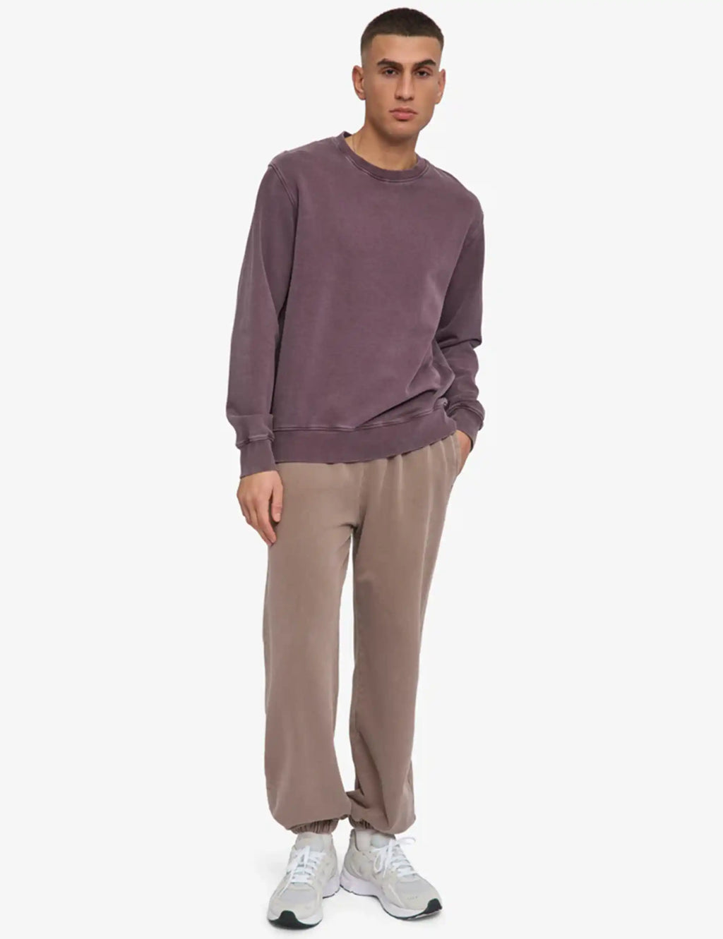 Faded grape crewneck sweatshirt with ribbed hem and long sleeves, worn with trousers