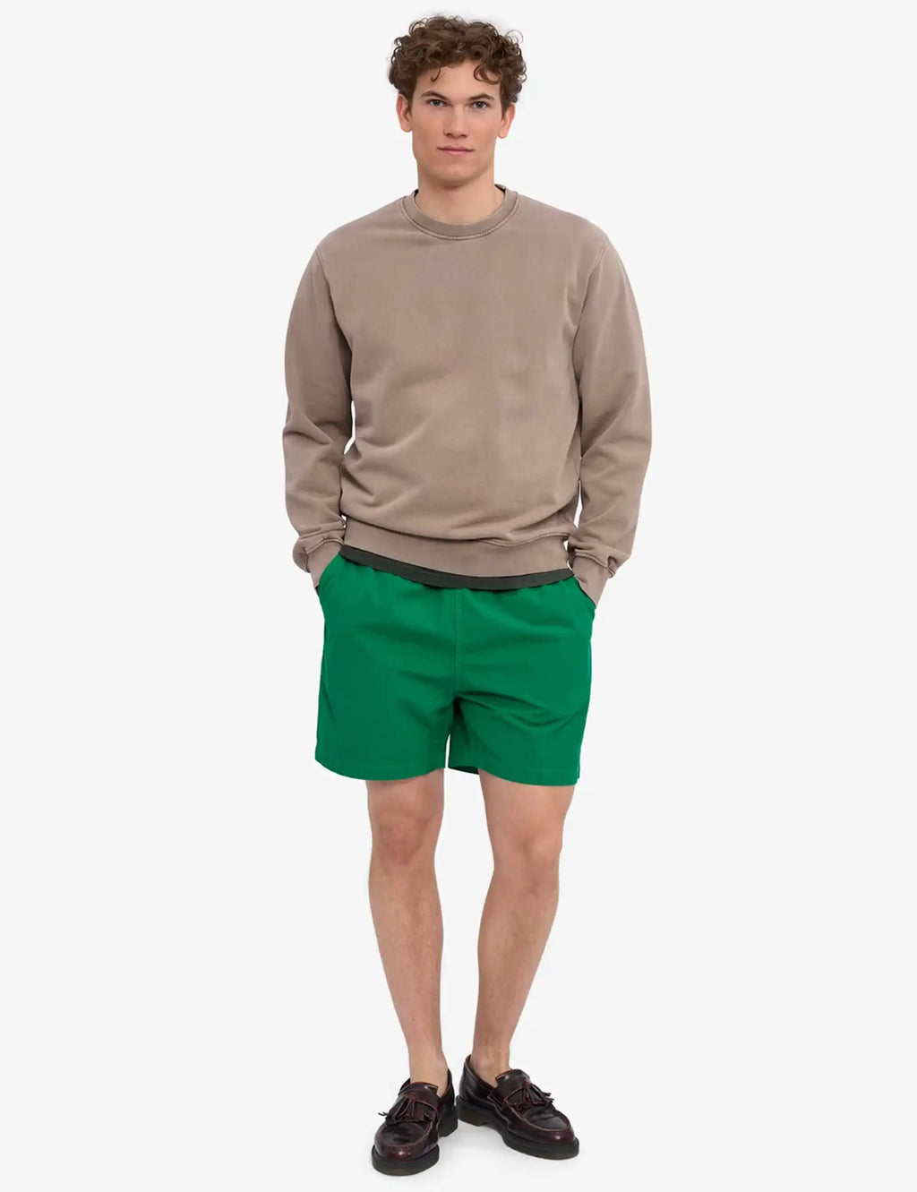 Men's organic crew sweatshirt in faded khaki, worn with long sleeves and ribbed cuffs