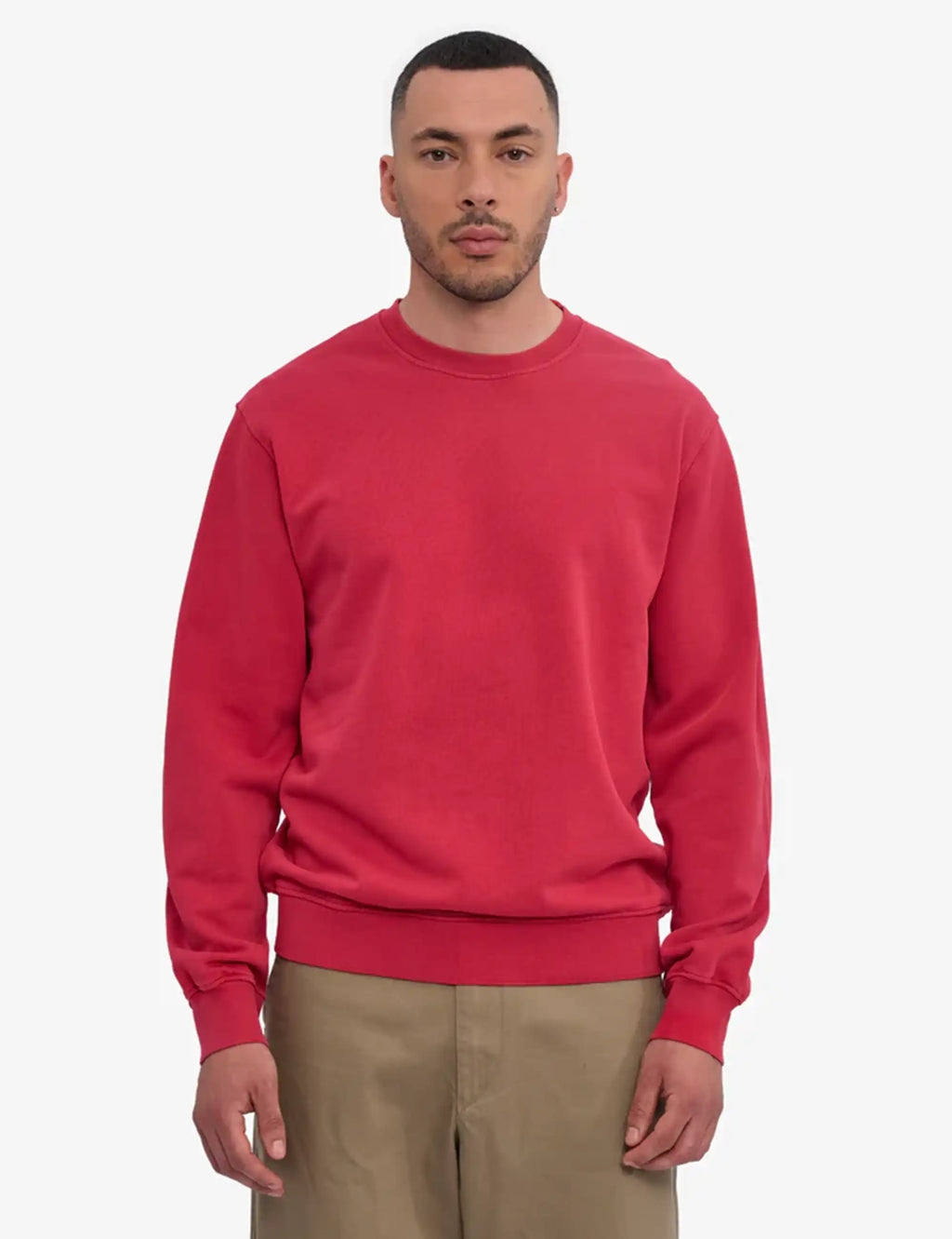 Faded red crew-neck sweatshirt with long sleeves and ribbed cuffs