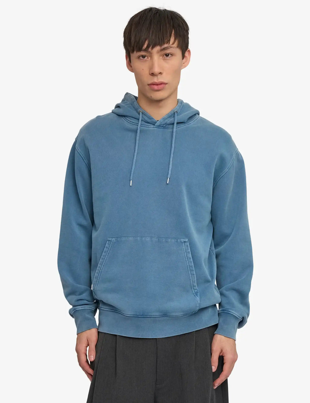 Faded indigo pullover hoodie with kangaroo pocket and adjustable drawstring hood.
