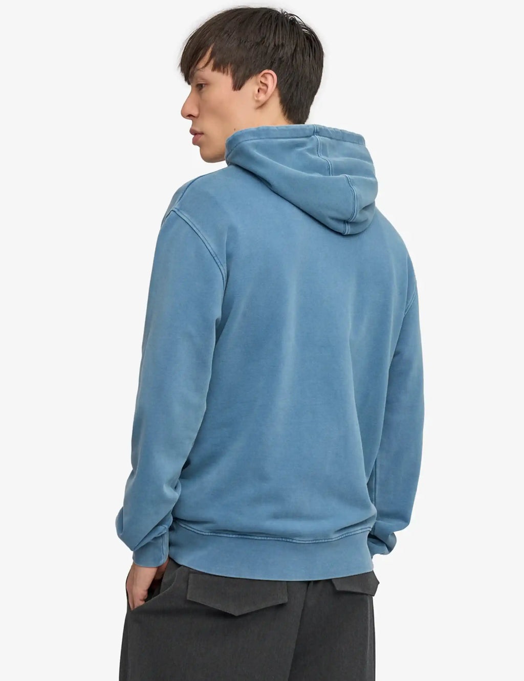Faded indigo hooded sweatshirt, rear view; adjustable hood with drawstring cords.