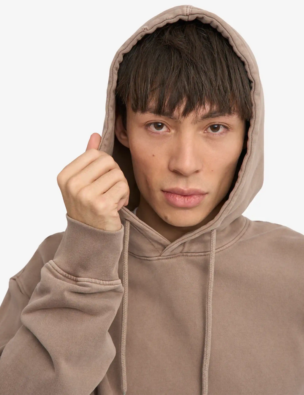 Faded khaki hoodie close-up with hood, drawstrings, and soft brushed fabric