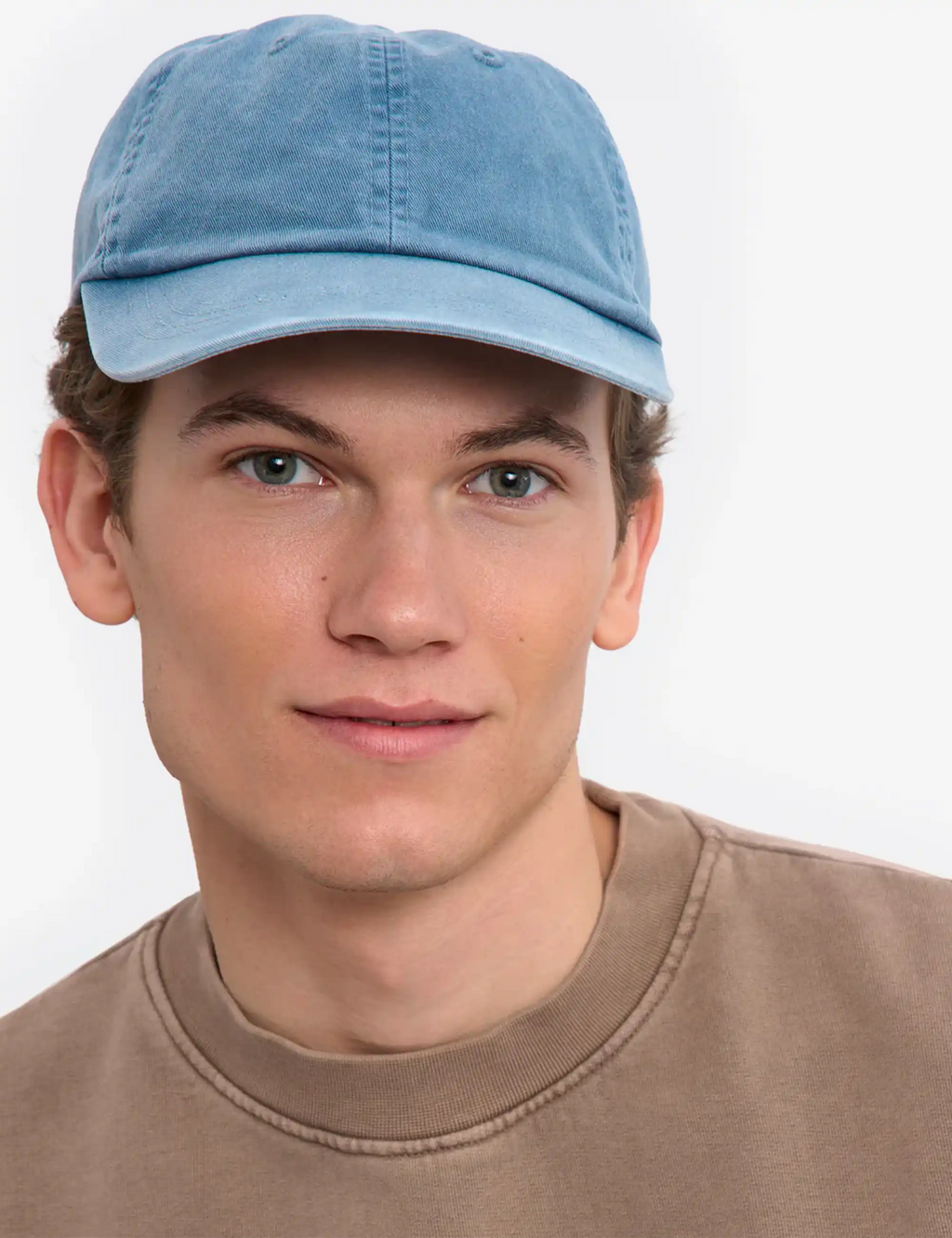 Faded indigo 6-panel organic cap with curved brim, front close-up on model