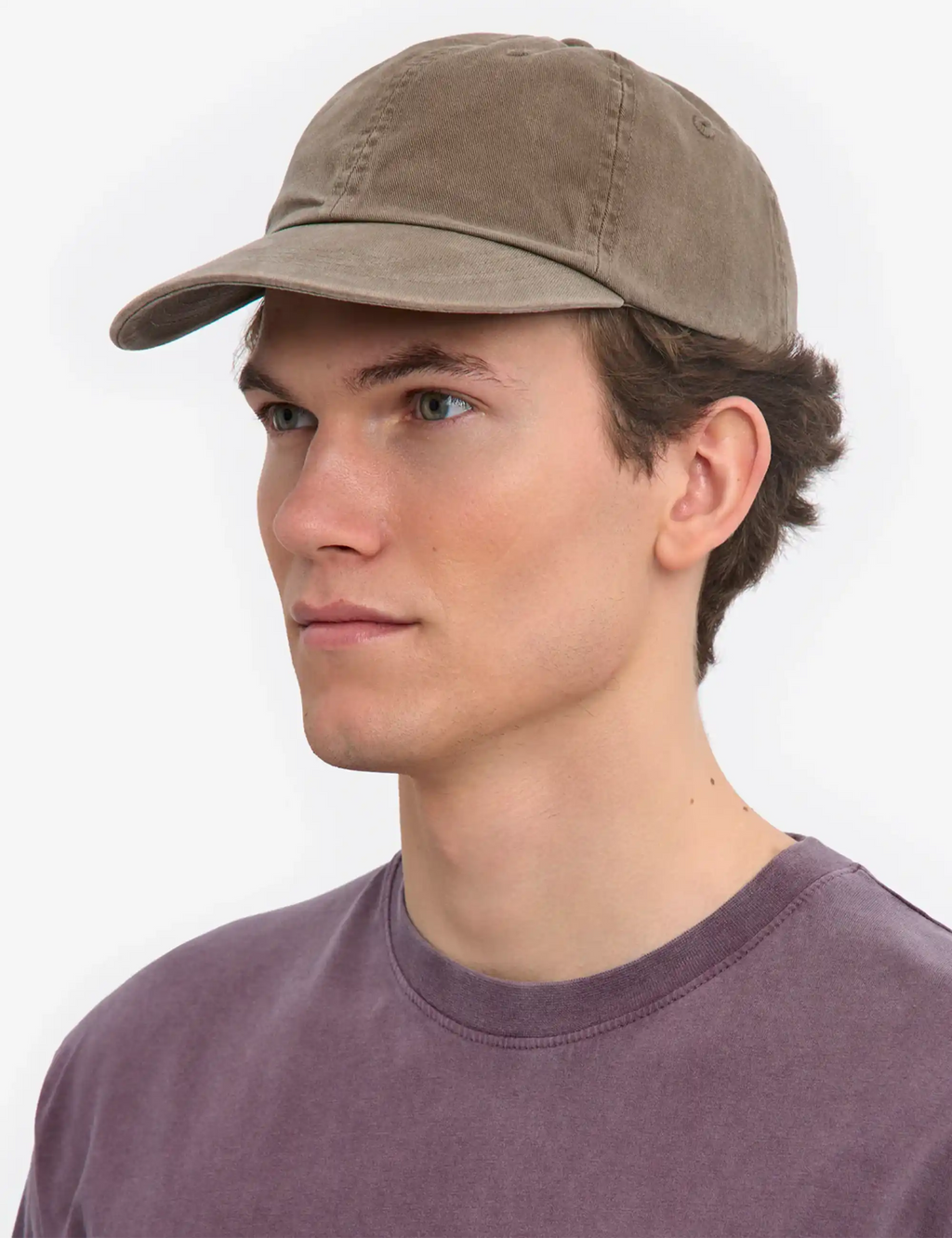Faded khaki 6-panel cap on model, curved brim, stitched panels