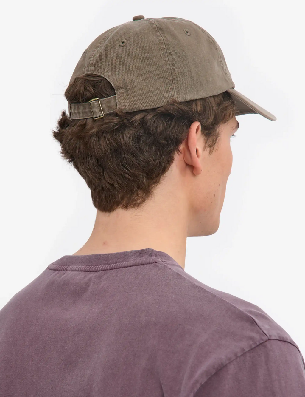 Faded khaki 6-panel cap from side/back, adjustable strap with metal buckle