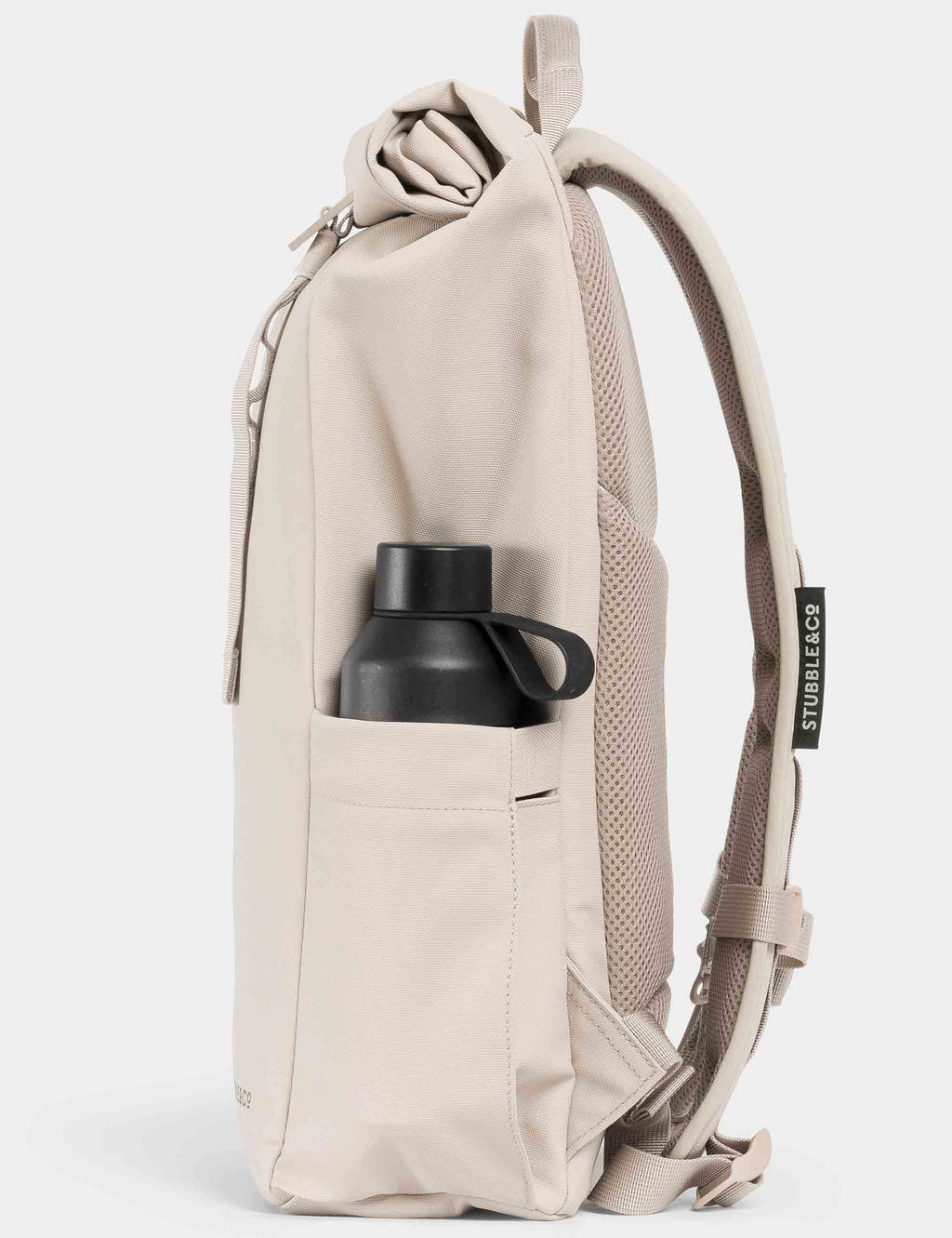 Roll-top backpack in tonal sand with side bottle sleeve holding a black bottle.