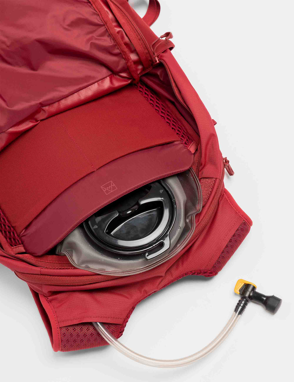 20L motion backpack in Magma red, hydration tube and zippered storage pouch