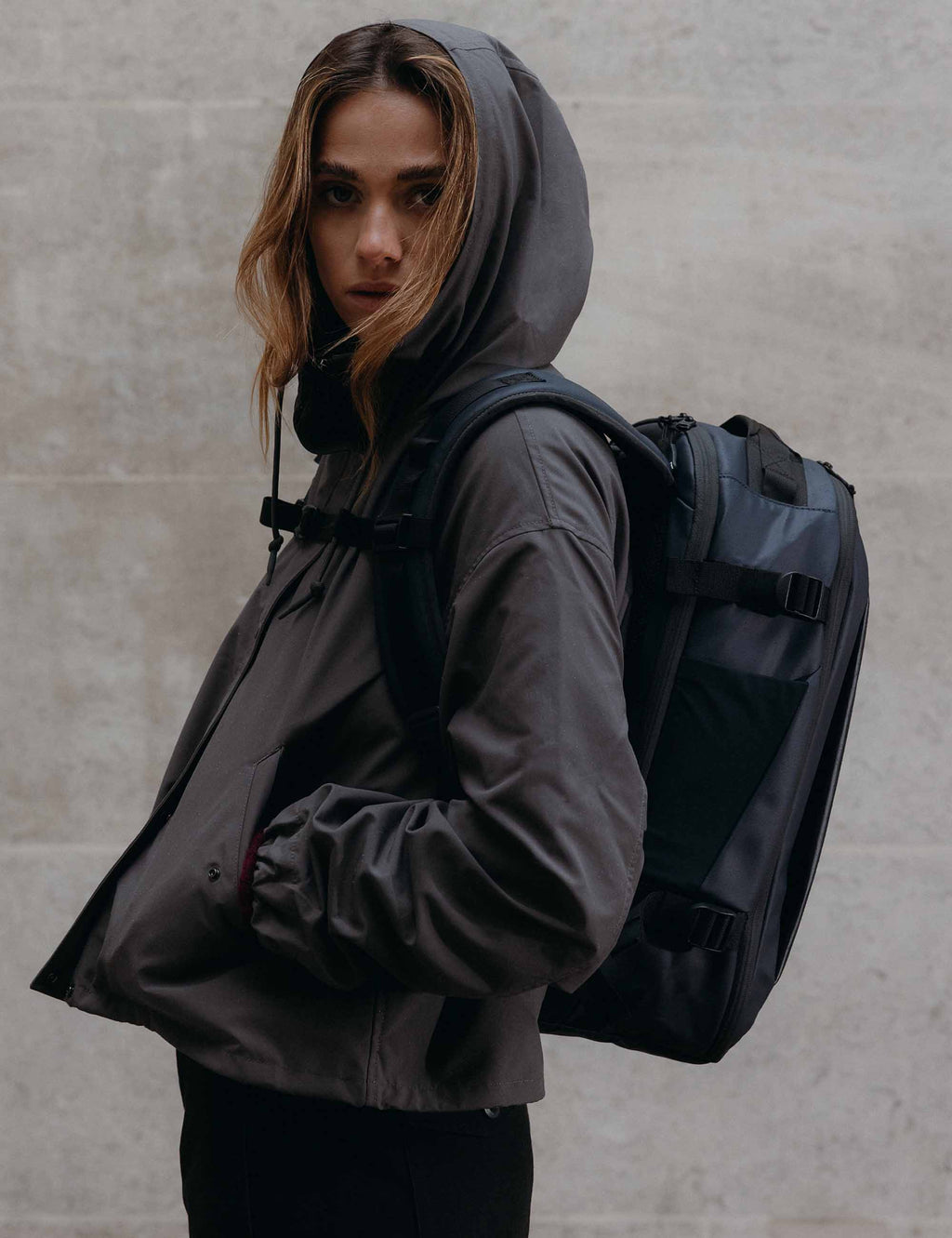 Midnight blue hybrid backpack worn on back with adjustable shoulder straps
