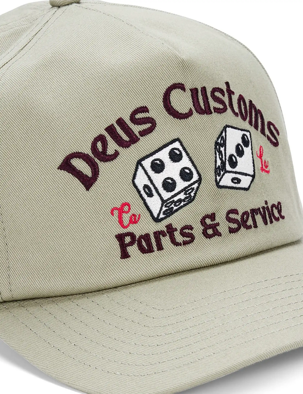 Light olive cap close-up of 'Deus Customs Parts & Service' logo and dice