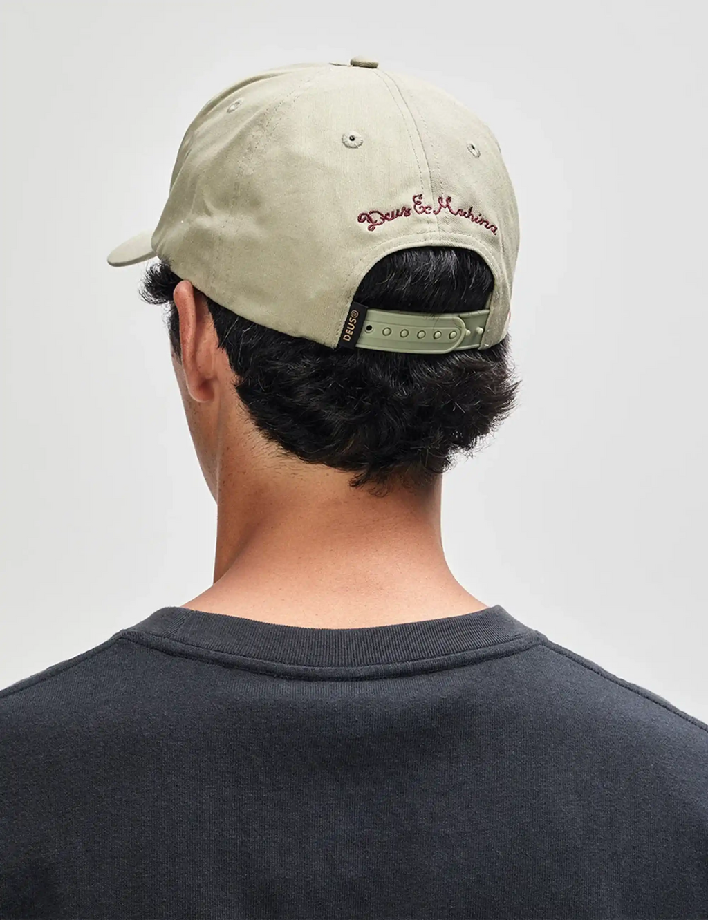 Light olive cap back view with 'Deus Ex Machina' embroidery and strap
